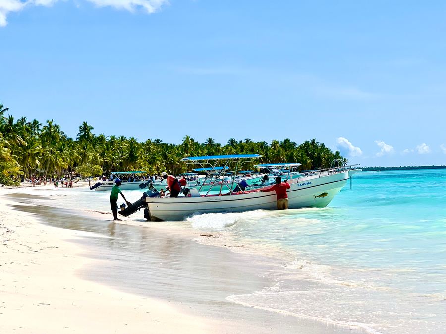 Boats resting on the white sand of a beach in the Dominican Republic
